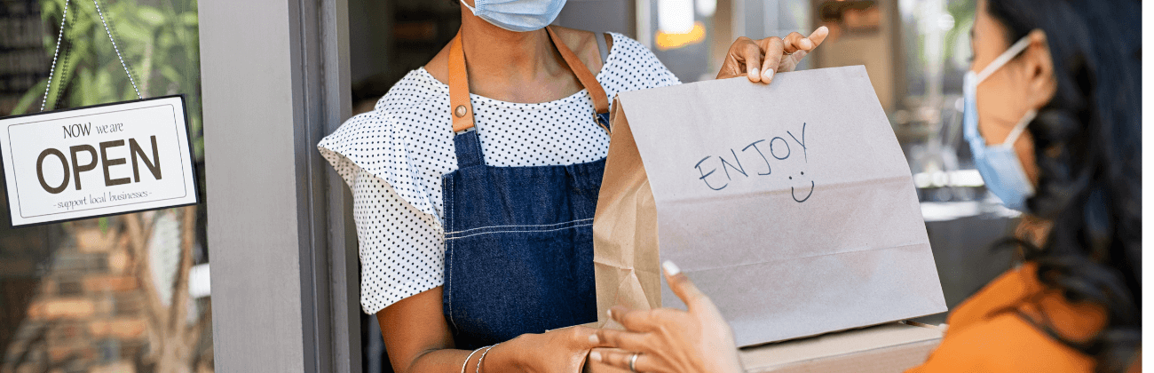 a woman collecting a food order from a restaurant