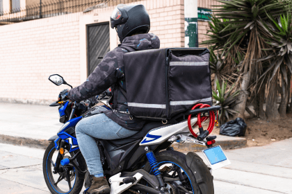 food delivery driver on a bike with a hot food bag on his back